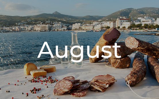A summer picnic with mountains and water in the background, labeled August.