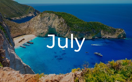 Scenic coastal view with clear blue waters and green hills, labeled July.
