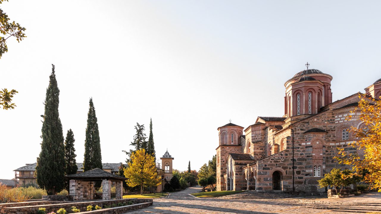 Monastery with trees and clear sky.