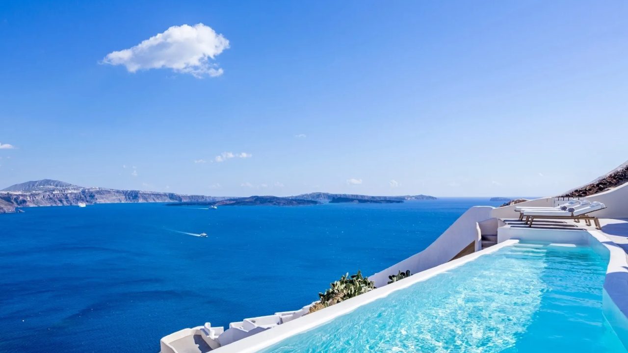 Infinity pool overlooking a blue ocean view.