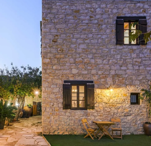 Authentic boutique hotel in Cyprus with stone walls and mountain views at sunset