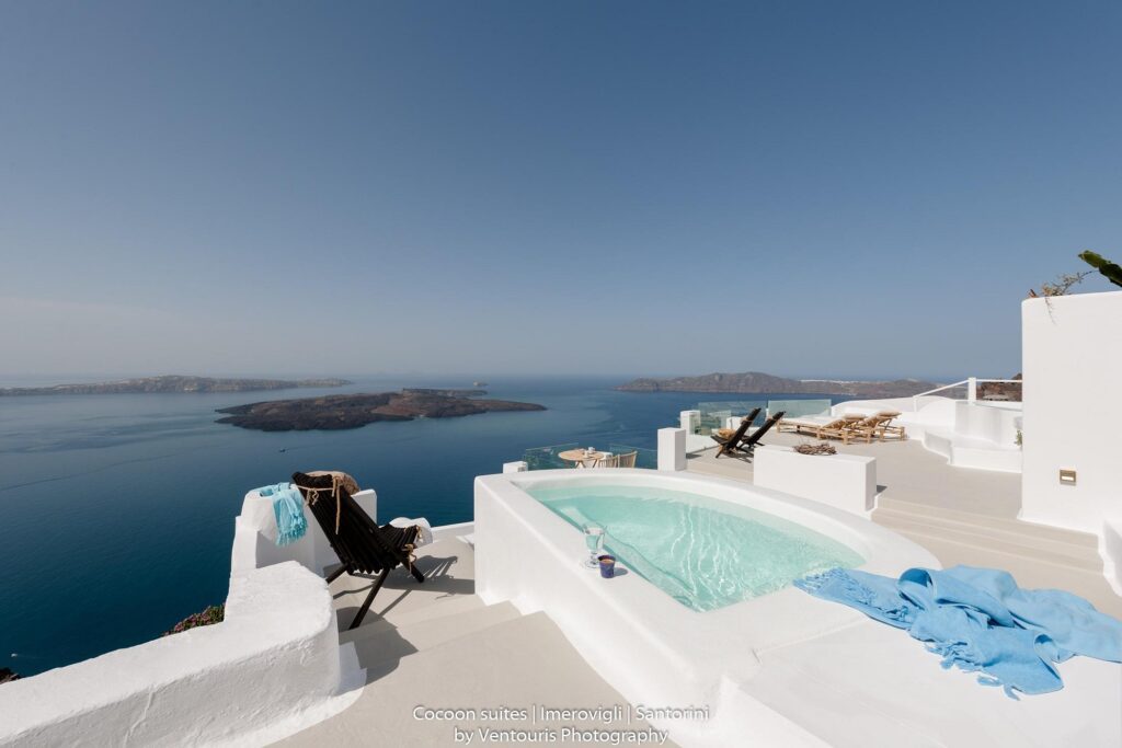 Luxurious infinity pool overlooking a serene ocean view at sunset.