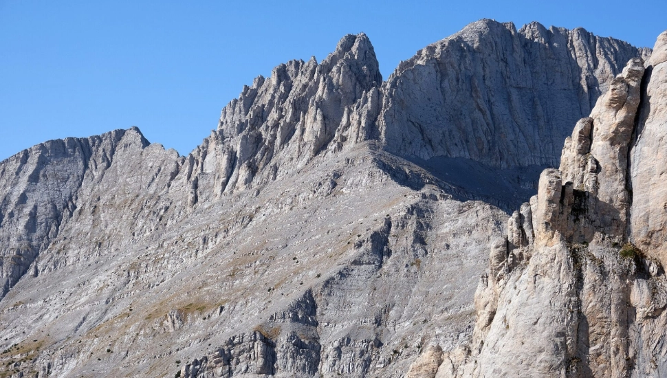 Rugged mountain peaks under a clear blue sky.