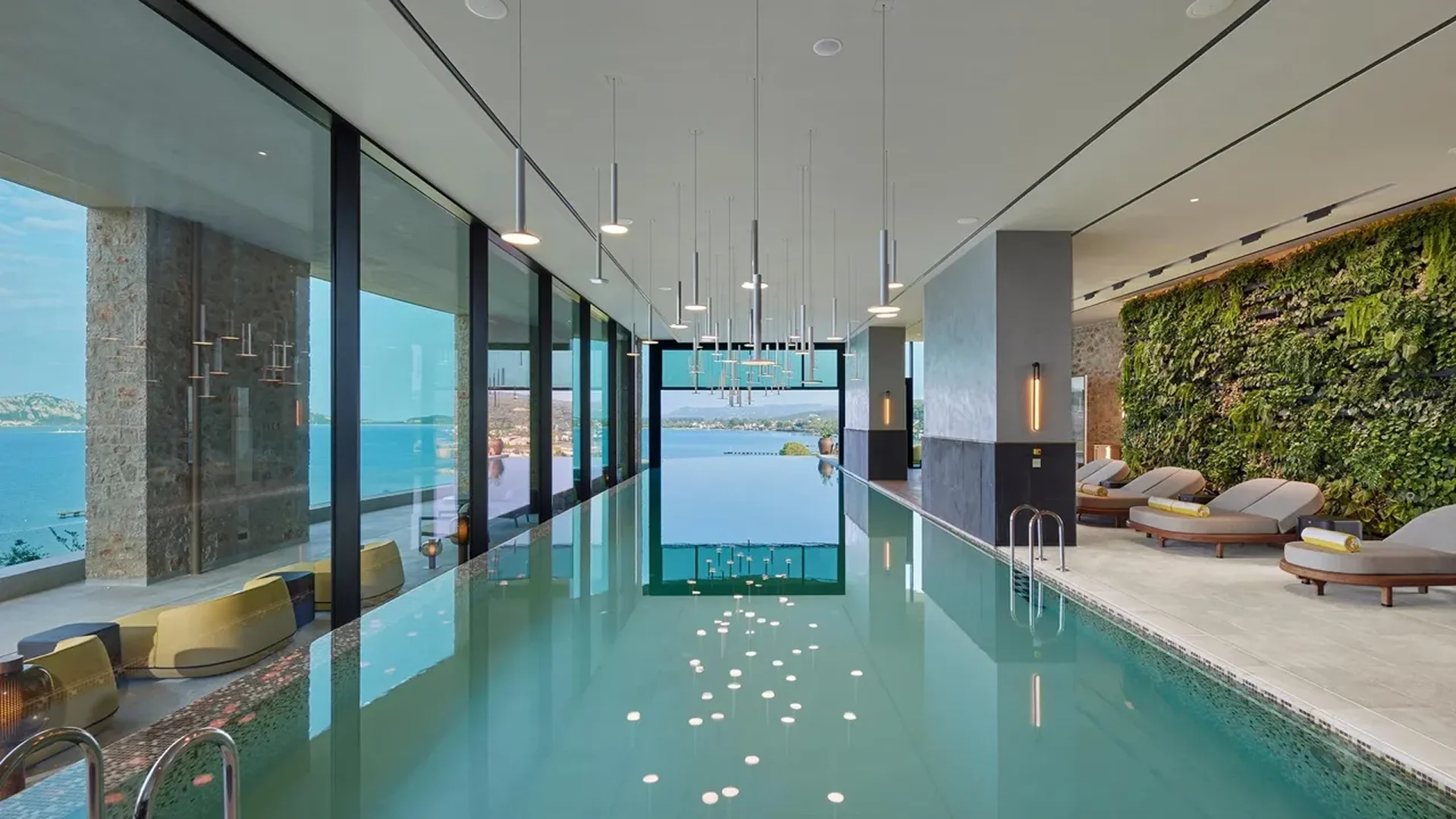 Modern indoor pool area with floor-to-ceiling windows and city views.