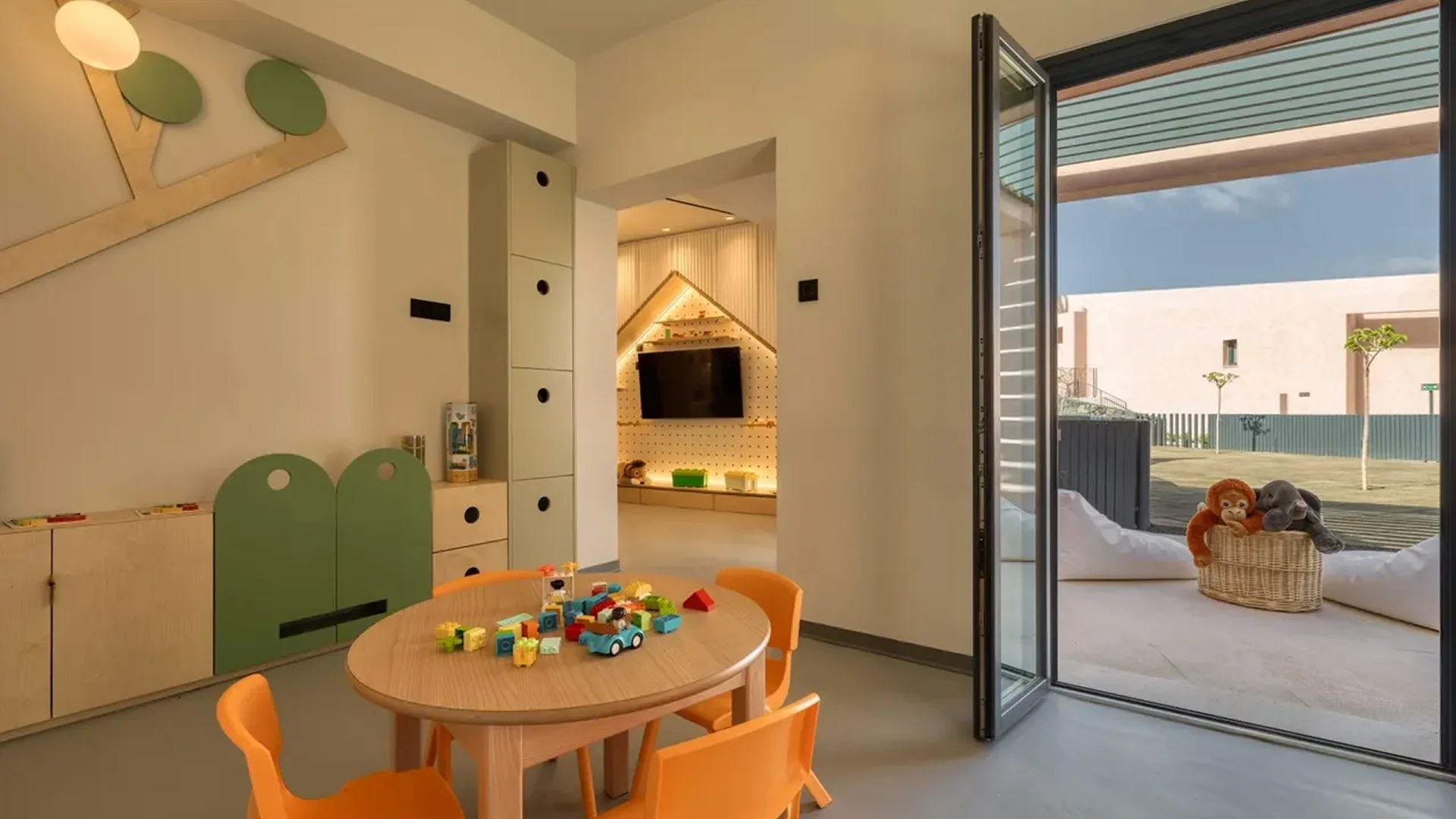 Bright children's playroom with colorful chairs and toys.