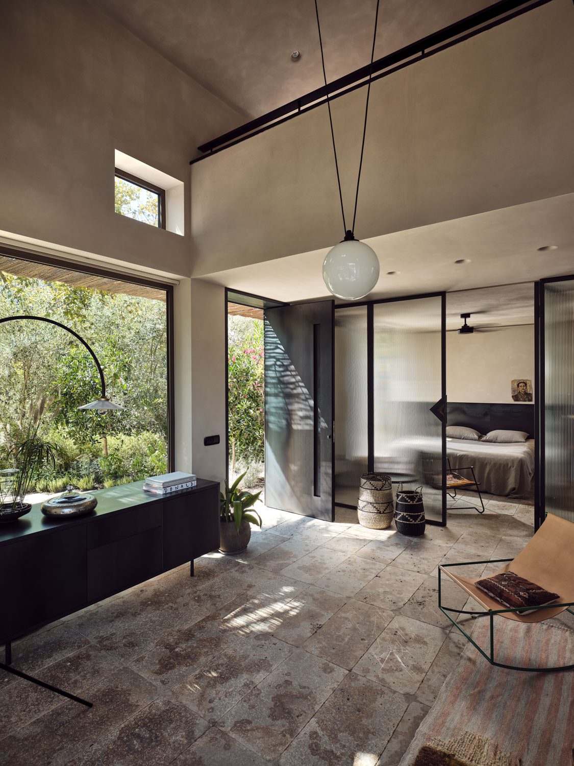 Modern living room with large windows and natural light.