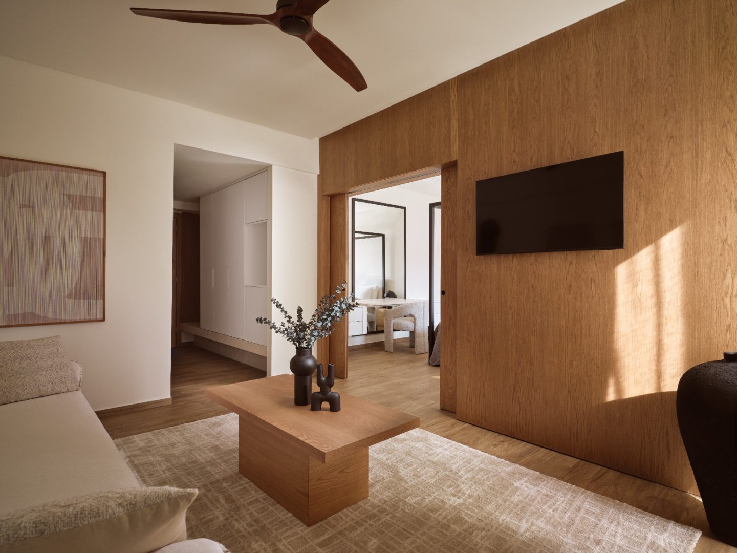 Modern living room with wooden accents and cozy seating.