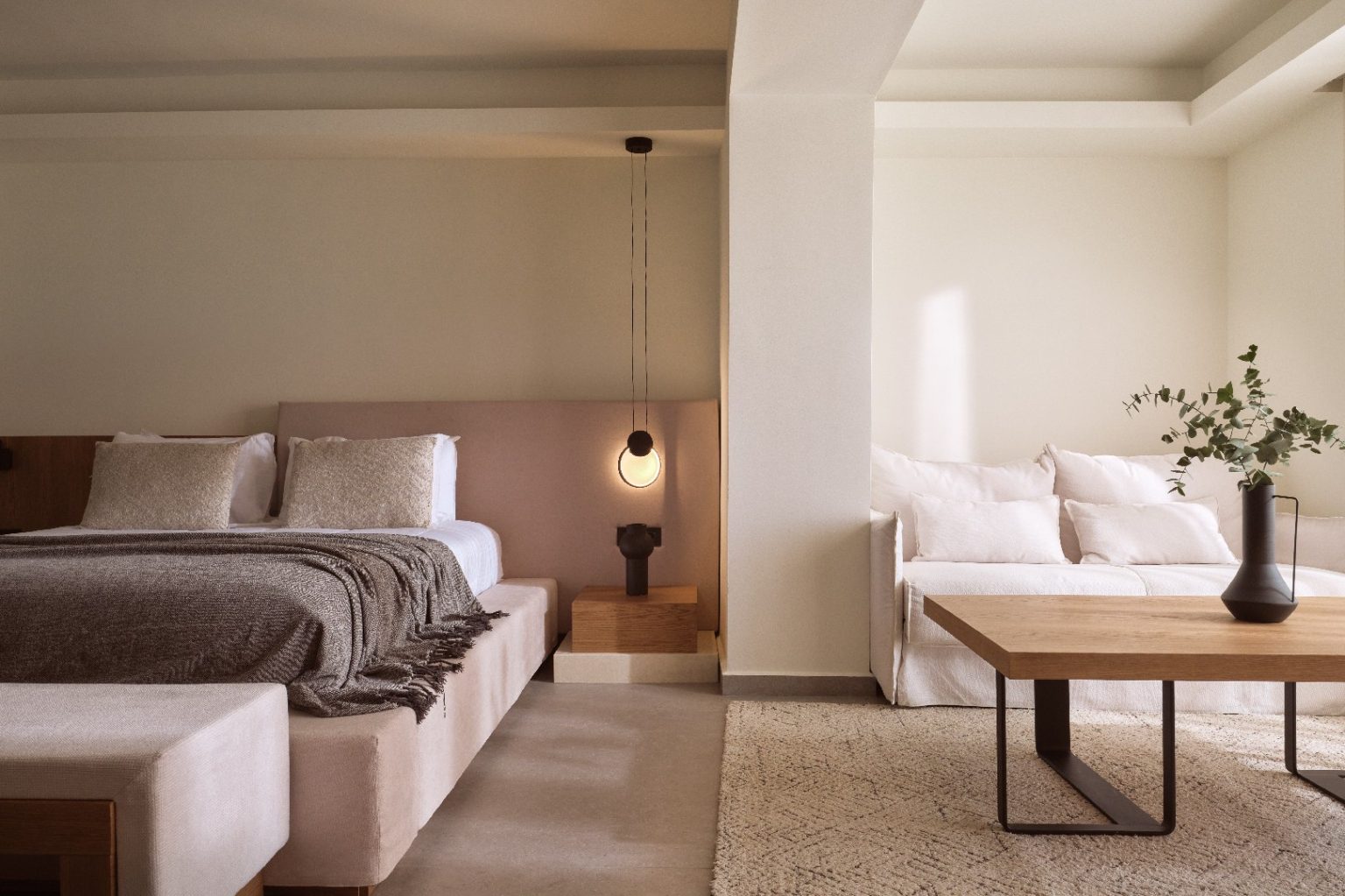 Minimalist bedroom with neutral tones and cozy bedding.
