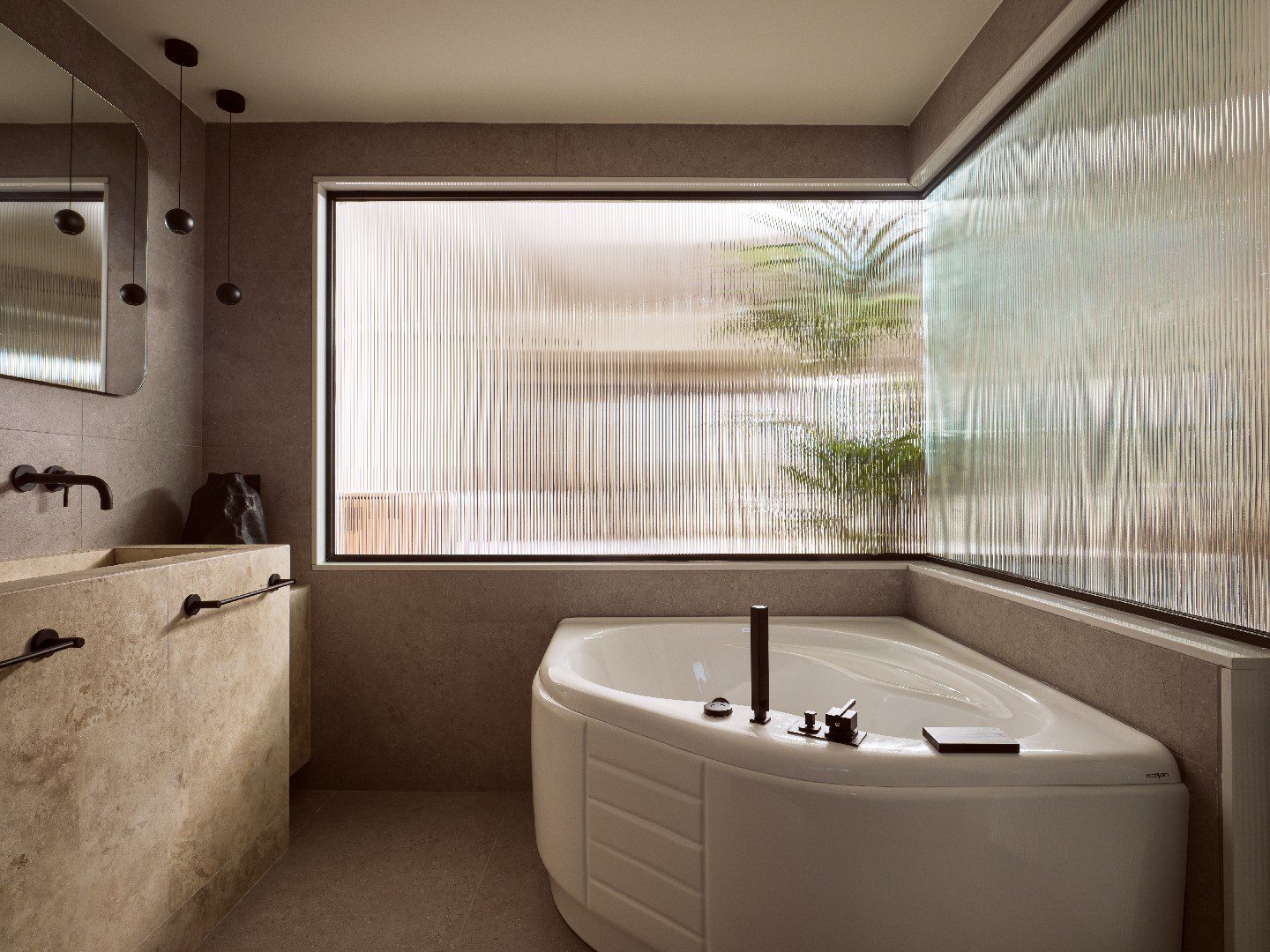 Modern bathroom with a deep soaking tub by a large window.