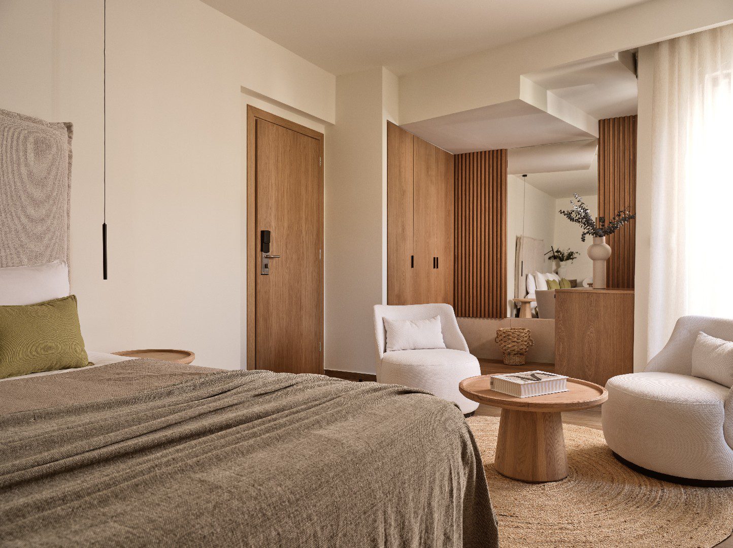 Cozy bedroom with neutral tones, wooden accents, and modern furniture.