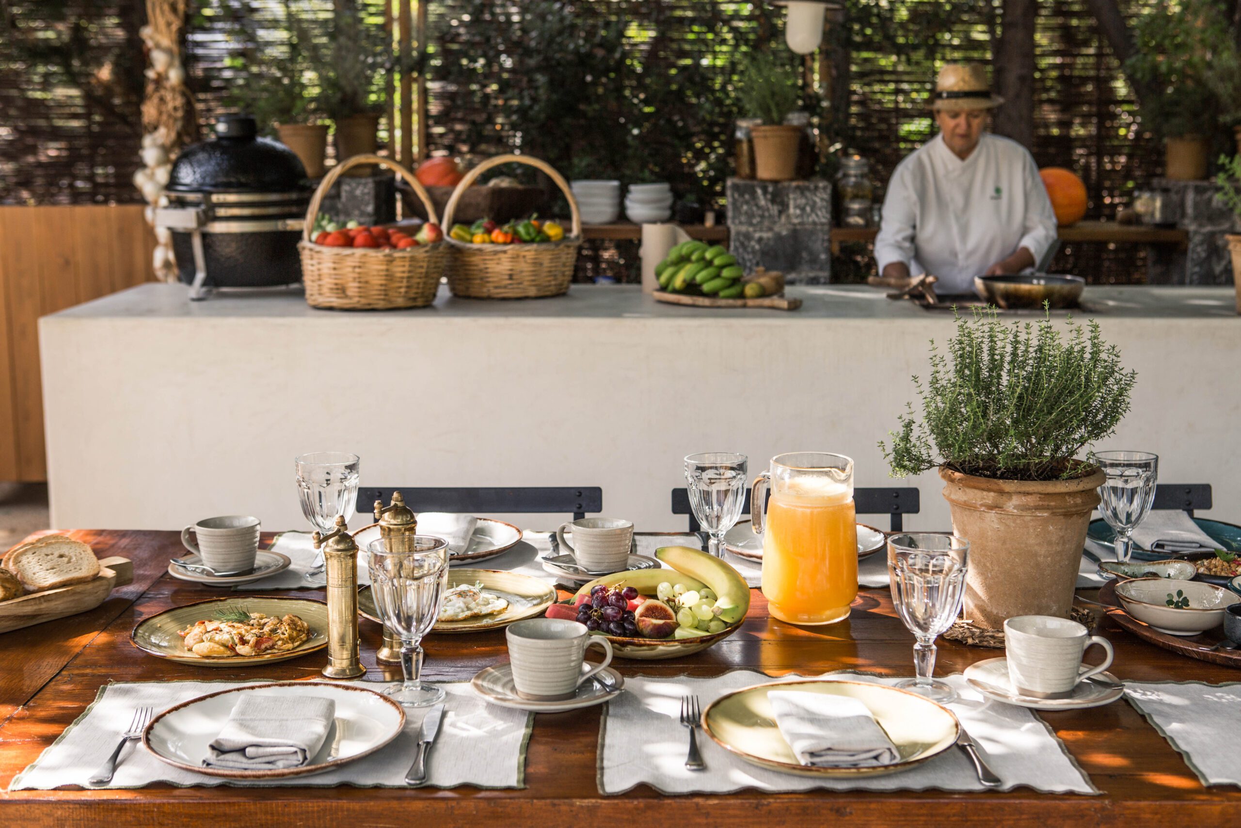 Elegant outdoor dining setup with fresh food and drinks.