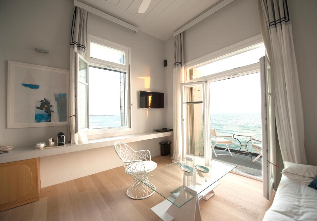 Bright modern living room with large windows and balcony.