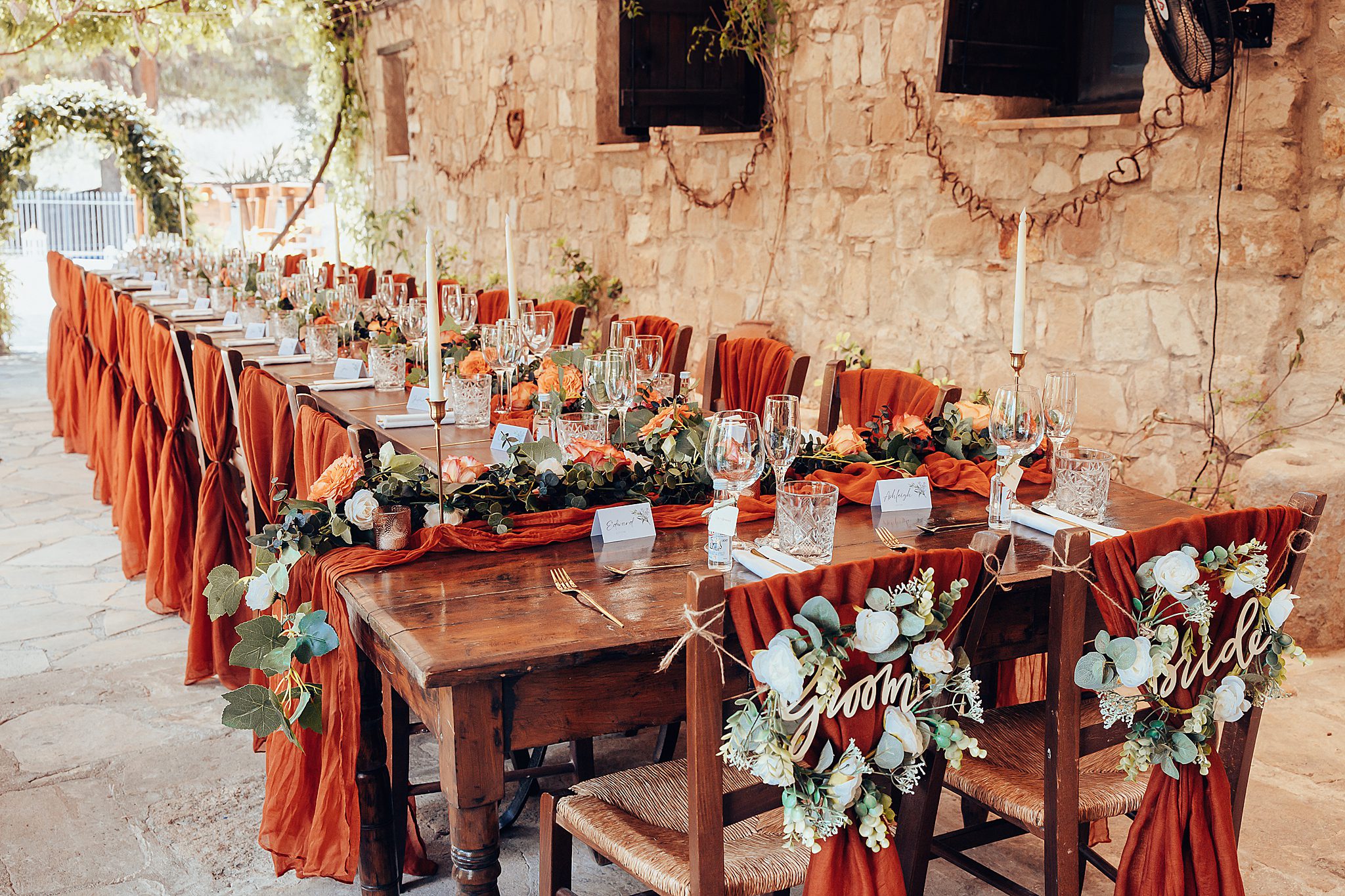 Rustic wedding table adorned with floral and candle decorations.