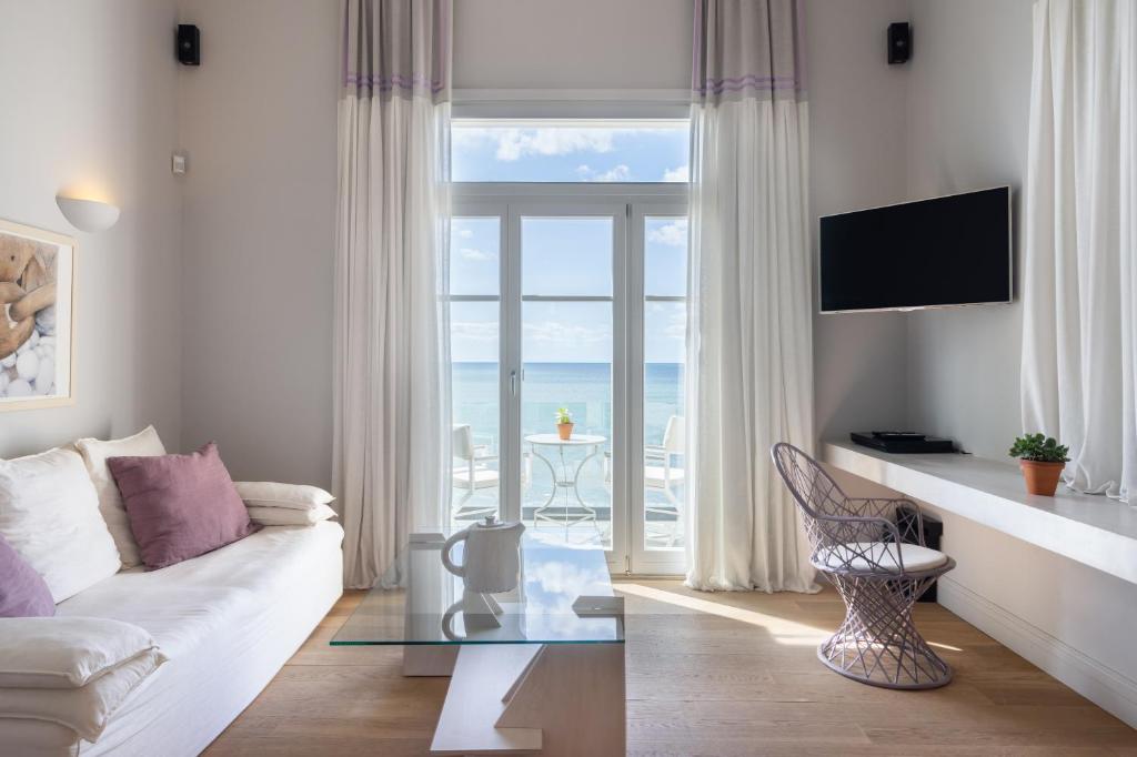 Bright living room with ocean view through large window.