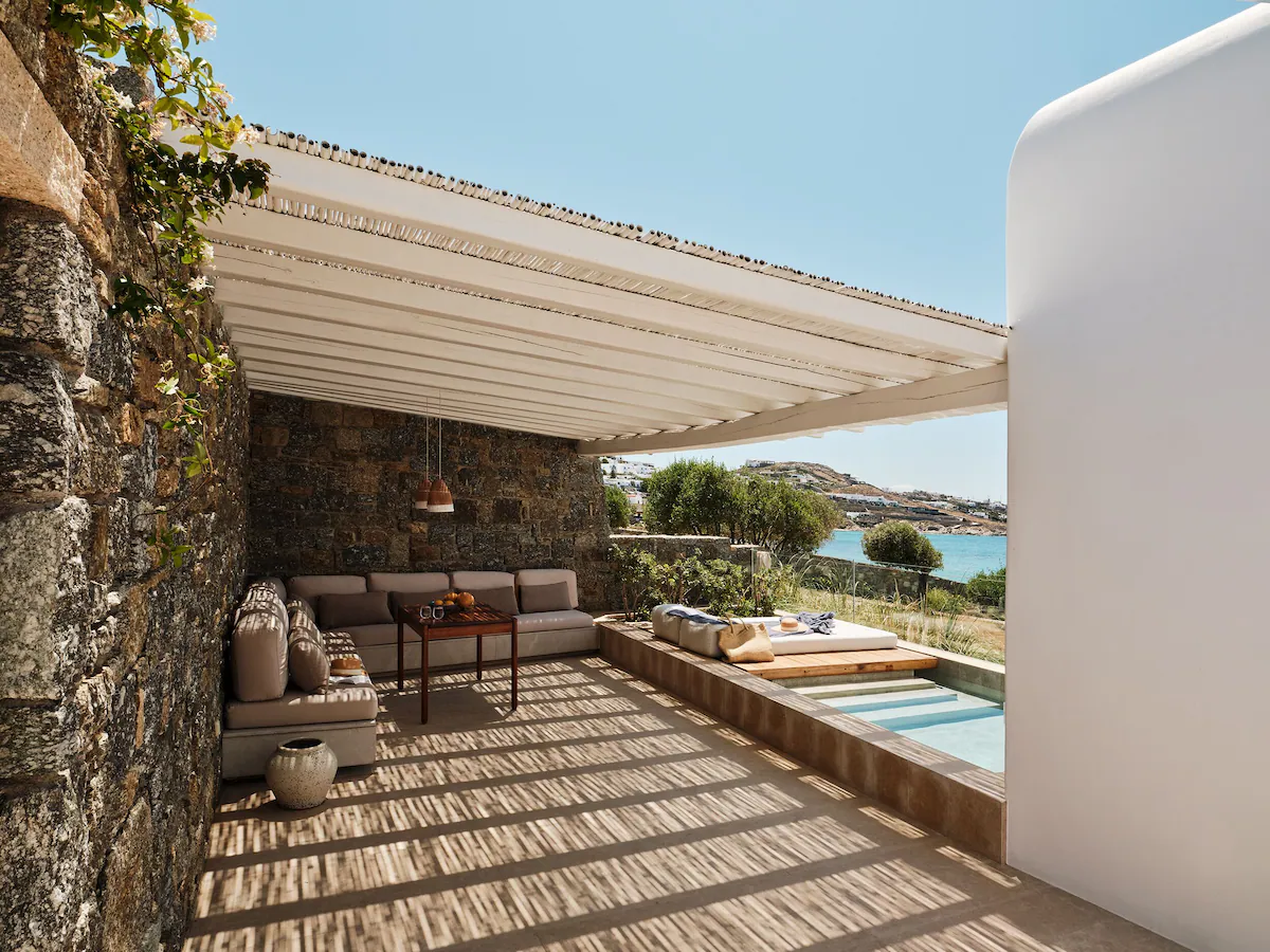 Modern suites with private infinity pools at Bill and Coo Mykonos overlooking the Aegean landscape.