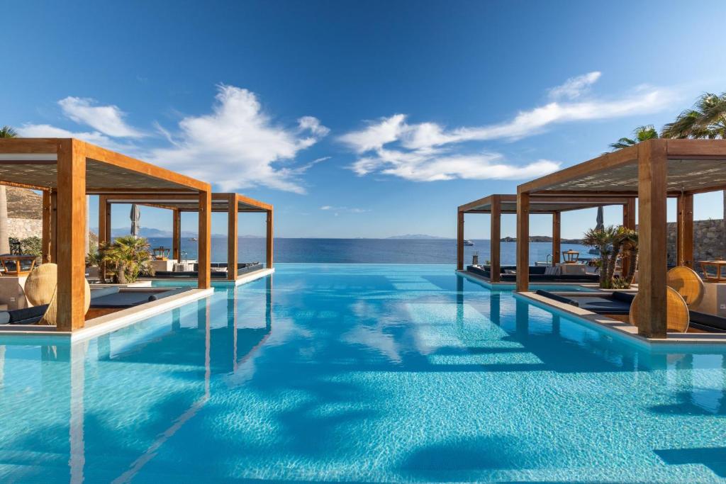 Infinity pool overlooking the ocean under a blue sky.