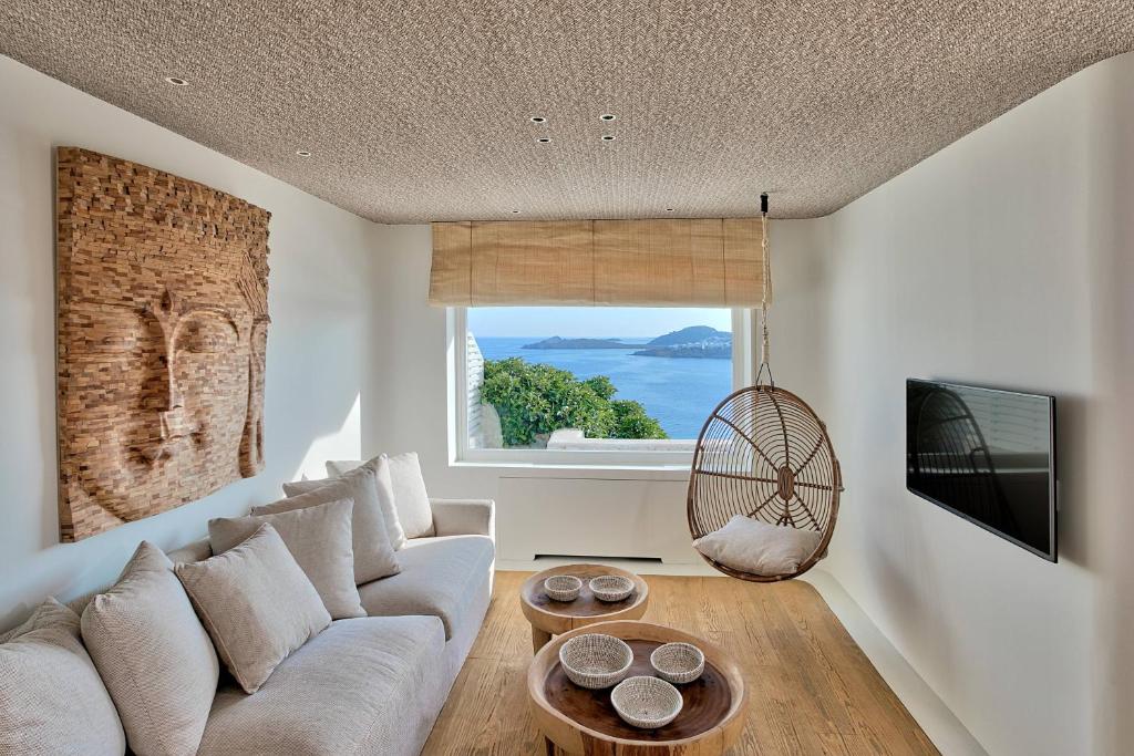 Cozy living room with sea view and hanging chair.