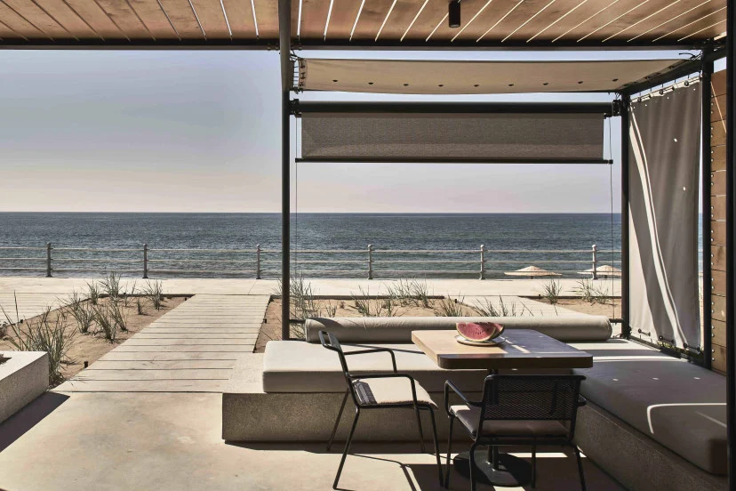 Modern dining area with ocean view and beach access.