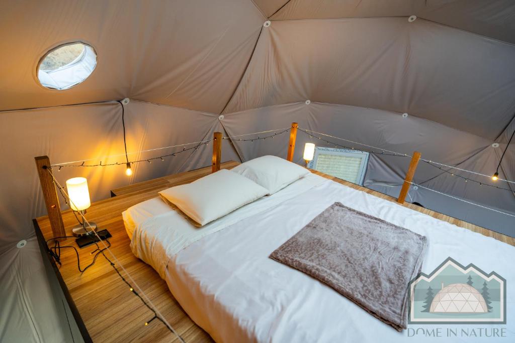Cozy tent bedroom with warm lighting and comfortable bed.