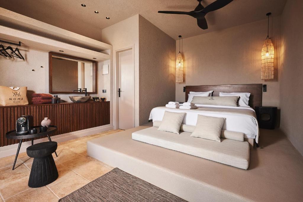 Modern bedroom with neutral tones and elegant lighting.