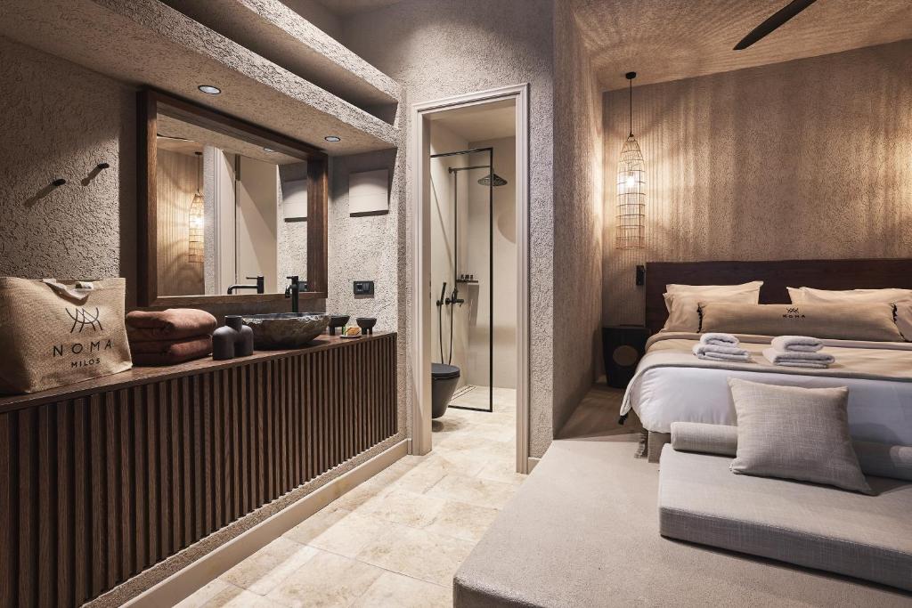 Modern hotel room with a bathroom and cozy bed.