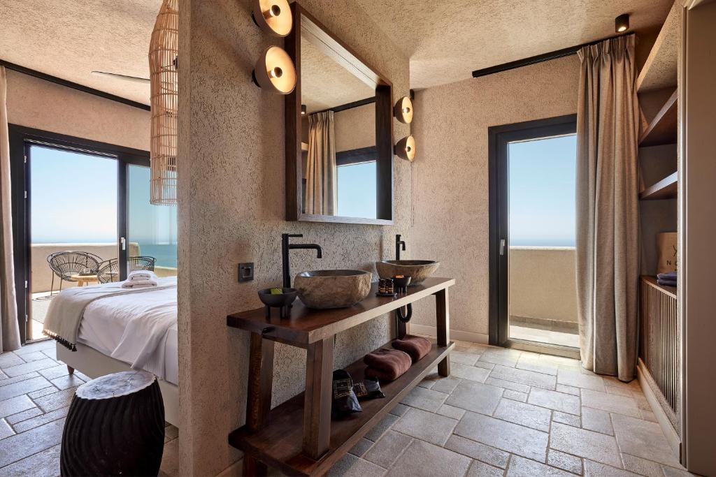 Rustic bathroom with stone sink and warm lighting.