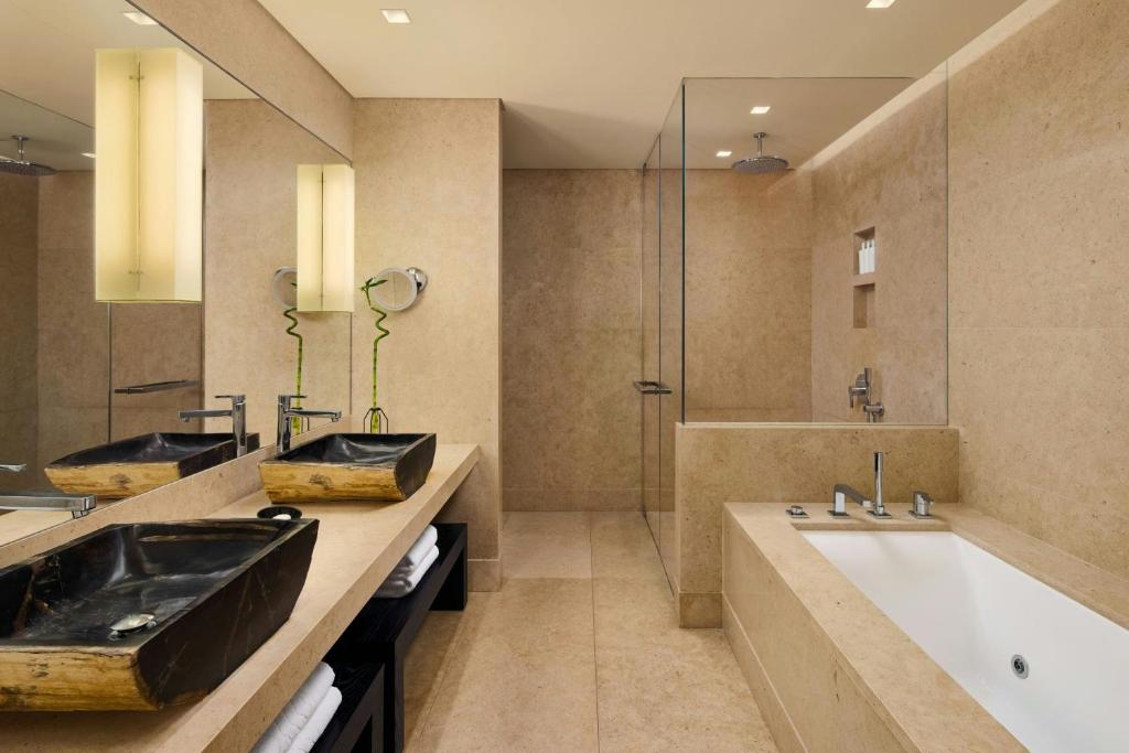 Modern bathroom with beige tones and glass shower.
