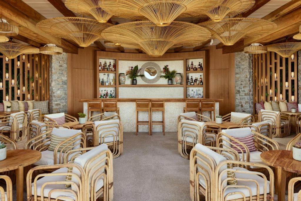 Cozy lounge with wicker furniture and an artistic wooden ceiling design.