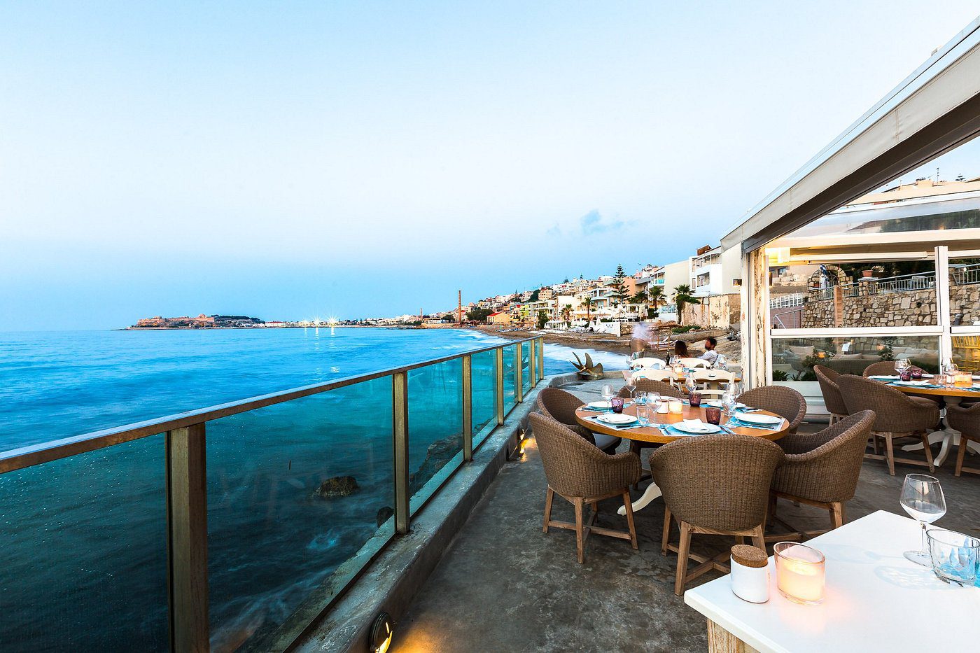 Seaside dining area with ocean views and clear blue skies.