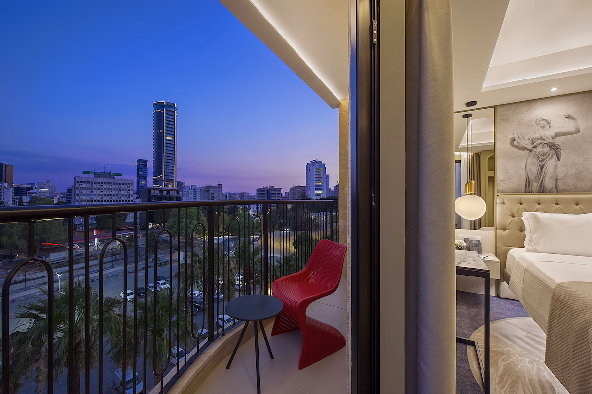 Balcony view of city skyline at twilight with modern decor.