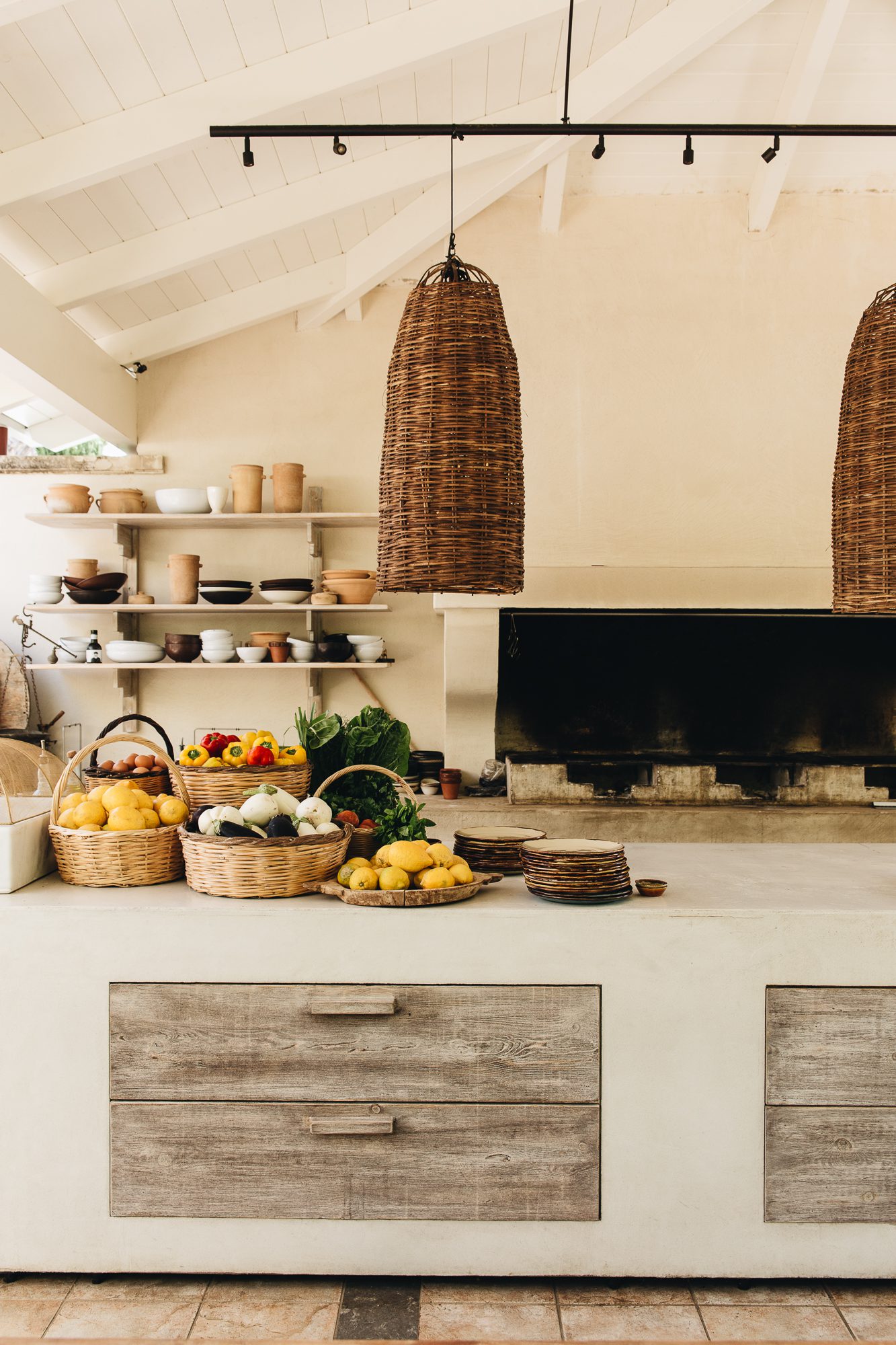 Rustic kitchen setup with woven baskets and fresh produce.