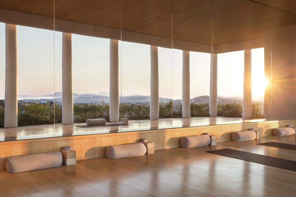 Spacious room with floor-to-ceiling windows overlooking a scenic mountain view.