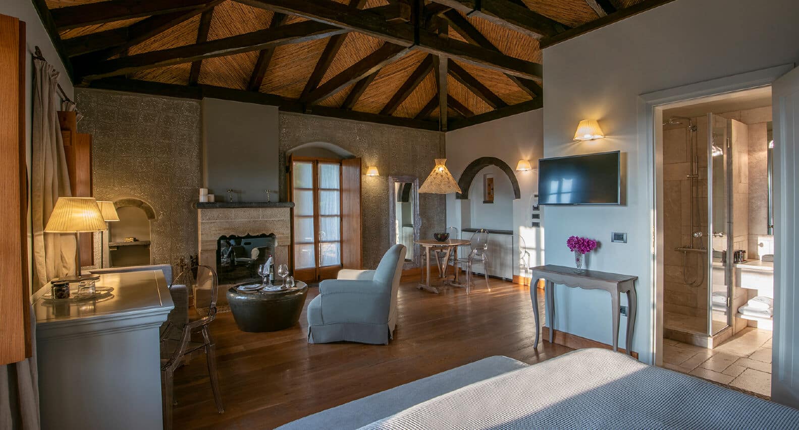 Cozy living area with rustic wooden ceiling and modern furnishings.