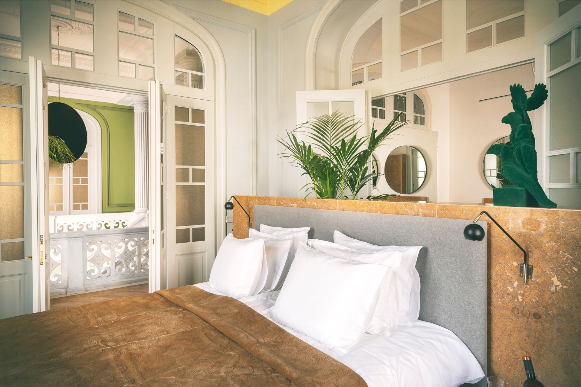 Cozy modern bedroom with white bedding and green accents.