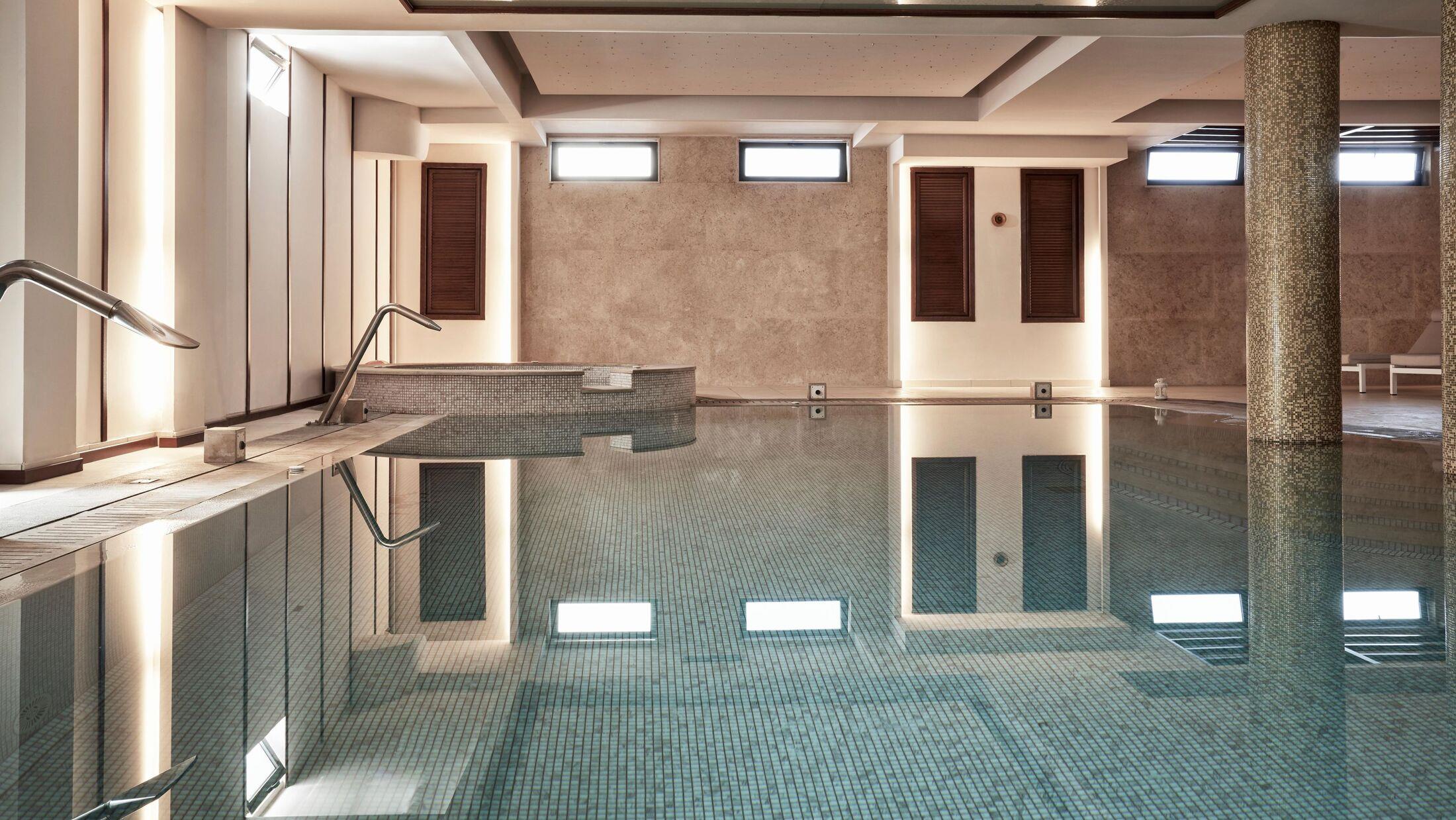 Indoor swimming pool with calm water and modern design.