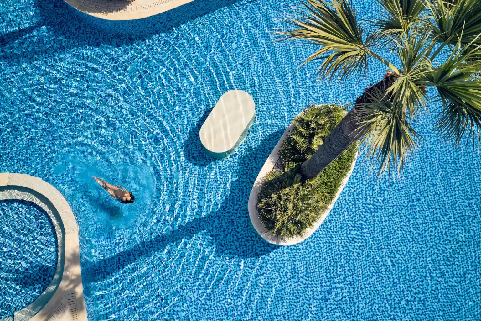 Lesante Classic luxury hotel pool in Zakynthos Greece, with palm trees and turquoise water.