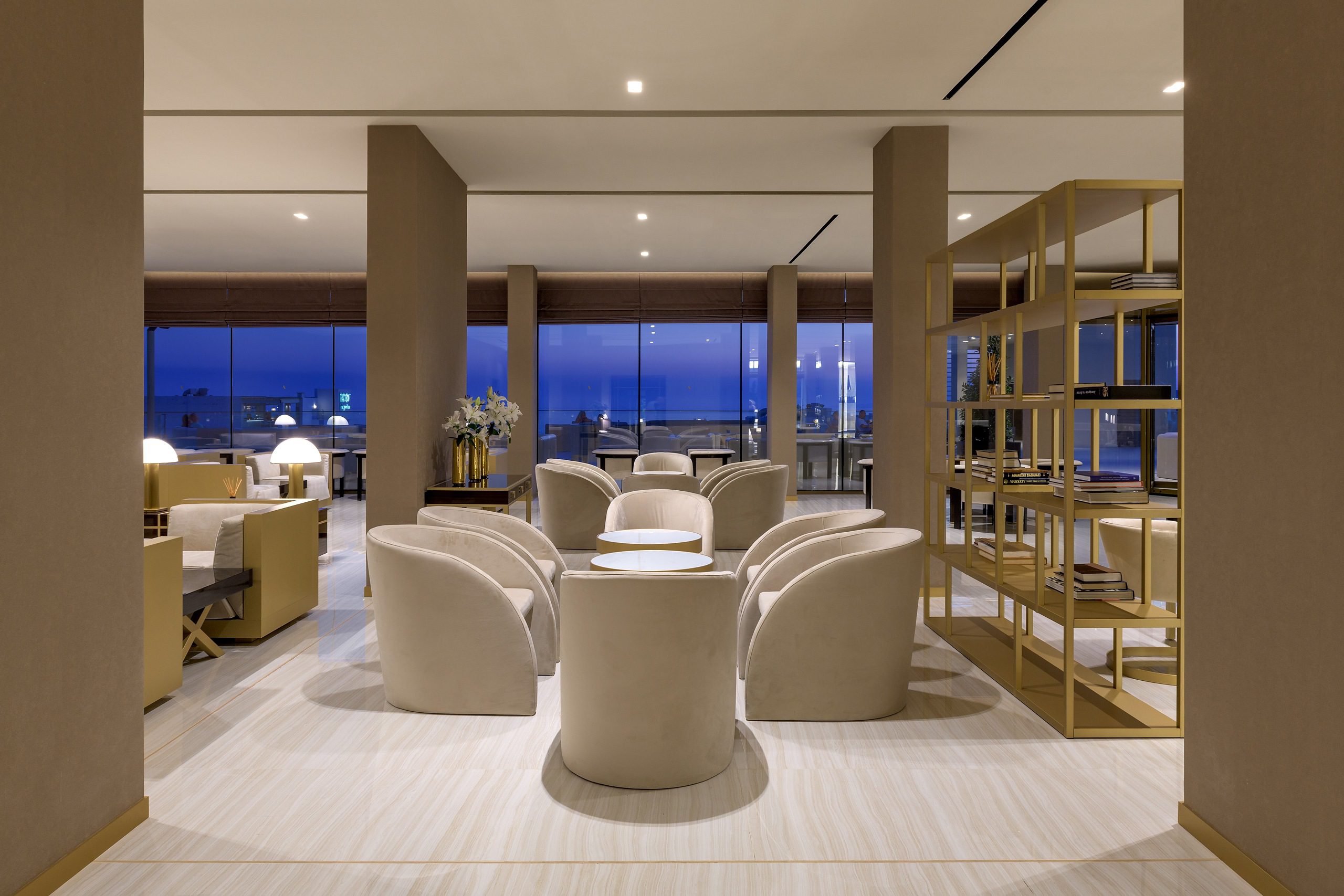 Elegant modern lounge with plush seating and panoramic windows.