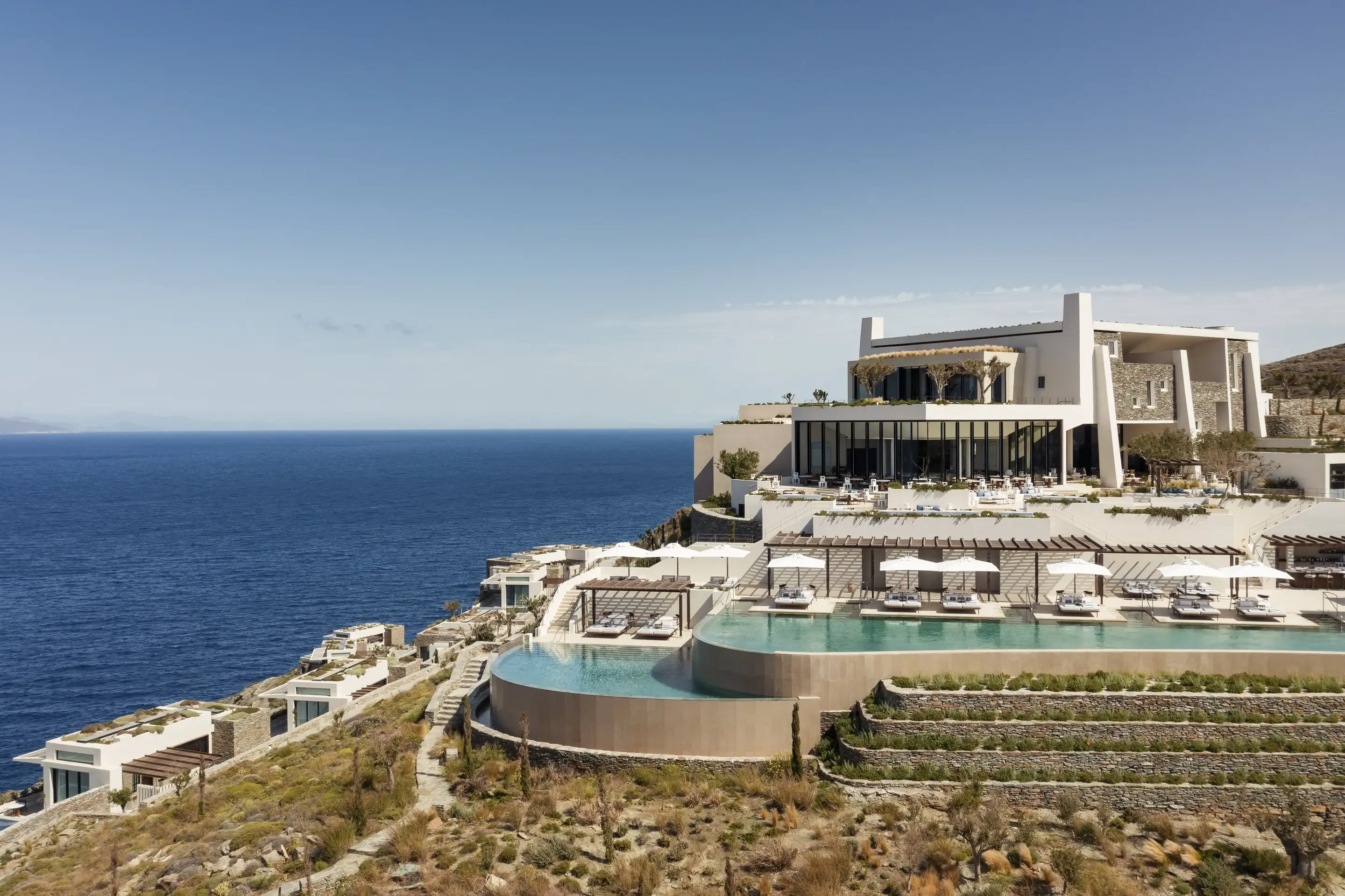 Luxury cliffside villa with multiple infinity pools overlooking the ocean.