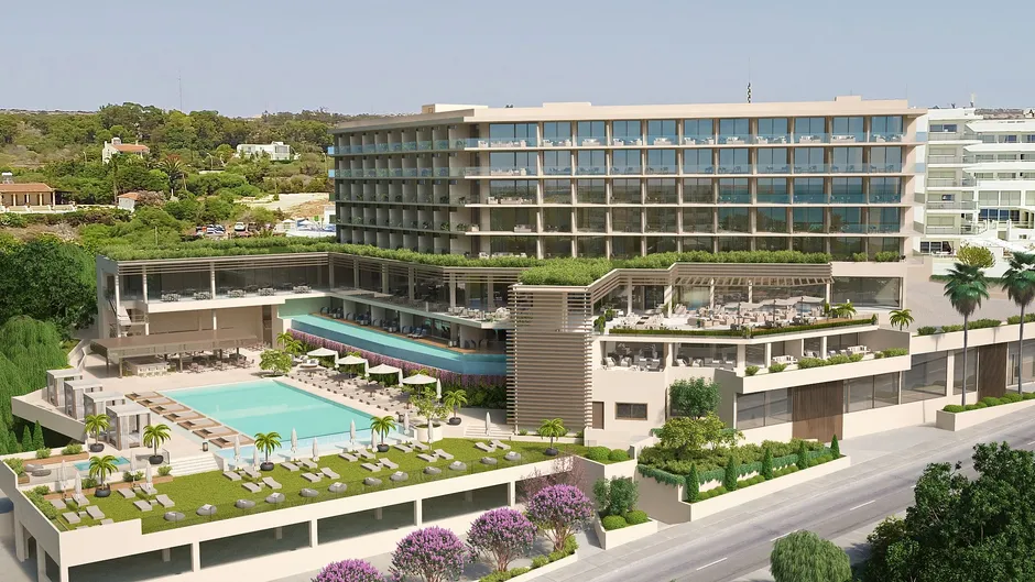 Modern hotel with a pool and landscaped gardens under clear skies.