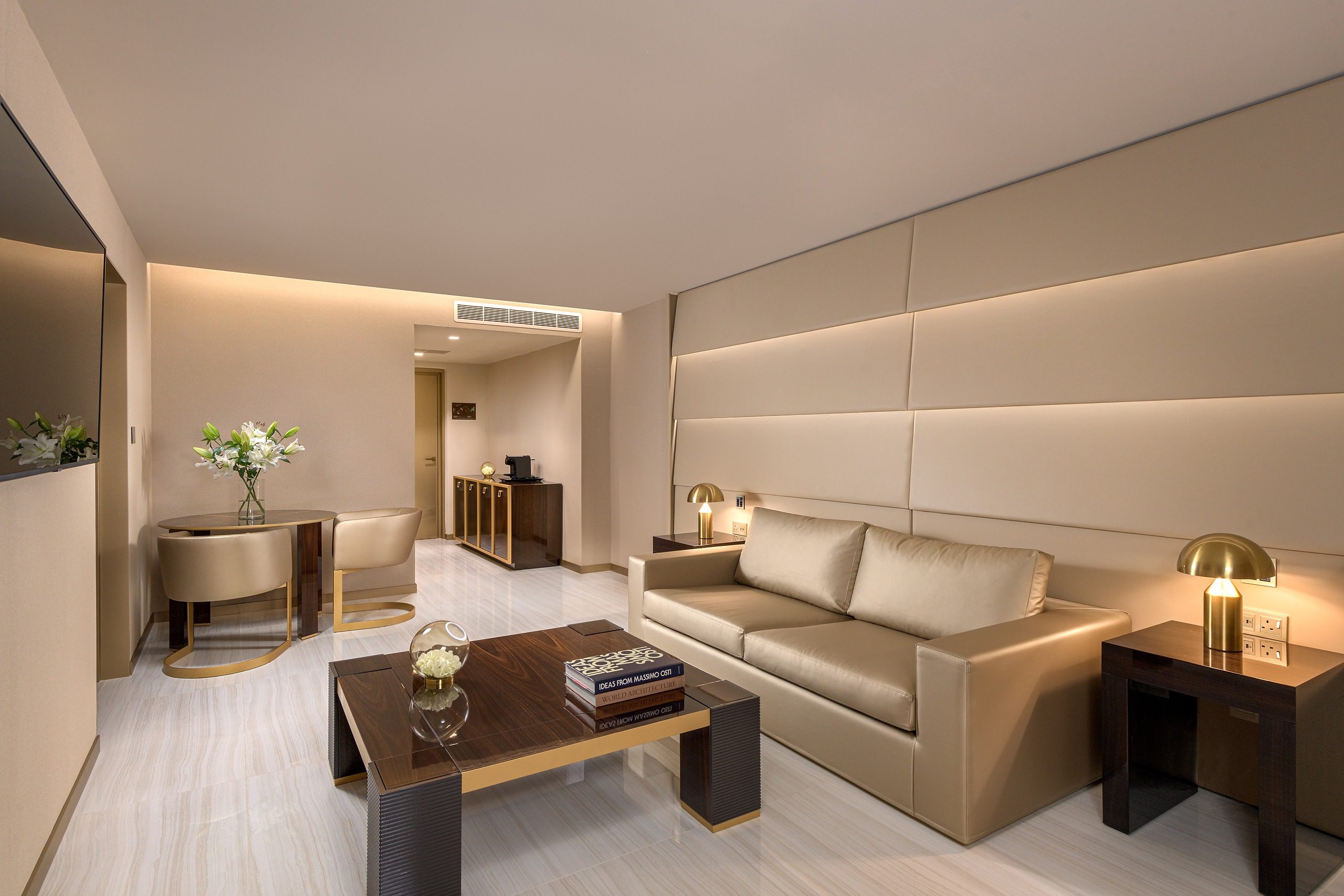 Modern living room with beige sofa and wooden coffee table.