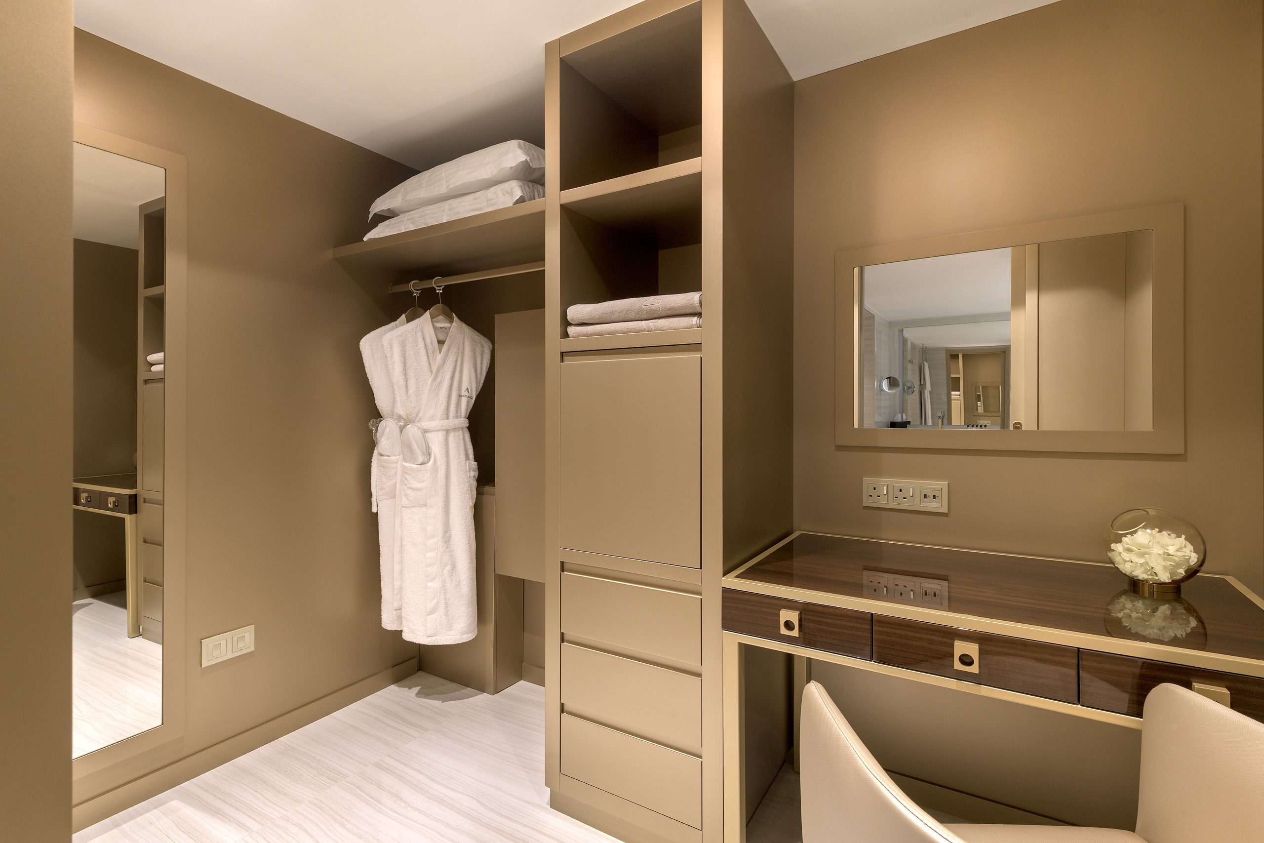 Elegant bathroom corner with storage and vanity area.