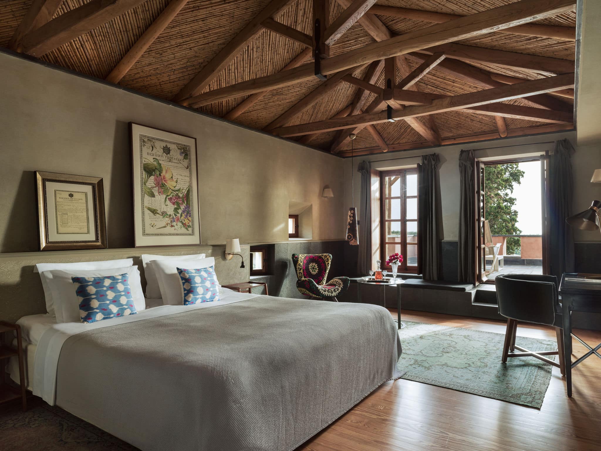 Cozy bedroom with wooden ceiling beams and natural light.