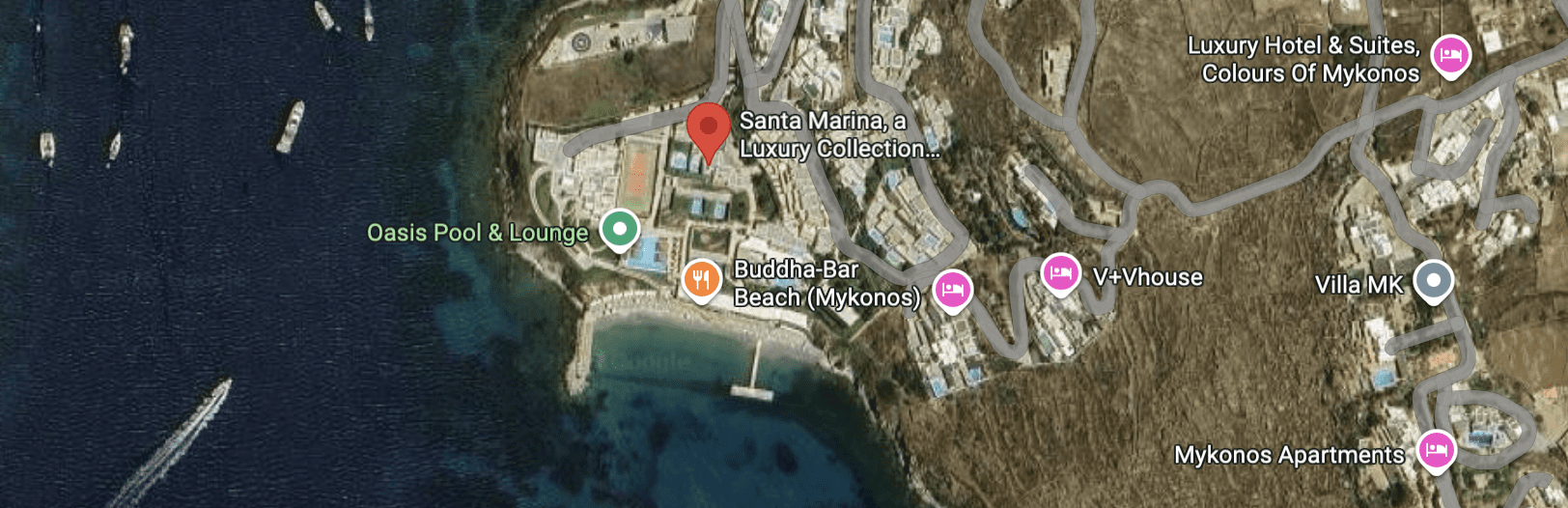 Aerial view of a beach area with resorts and restaurants near the coast.