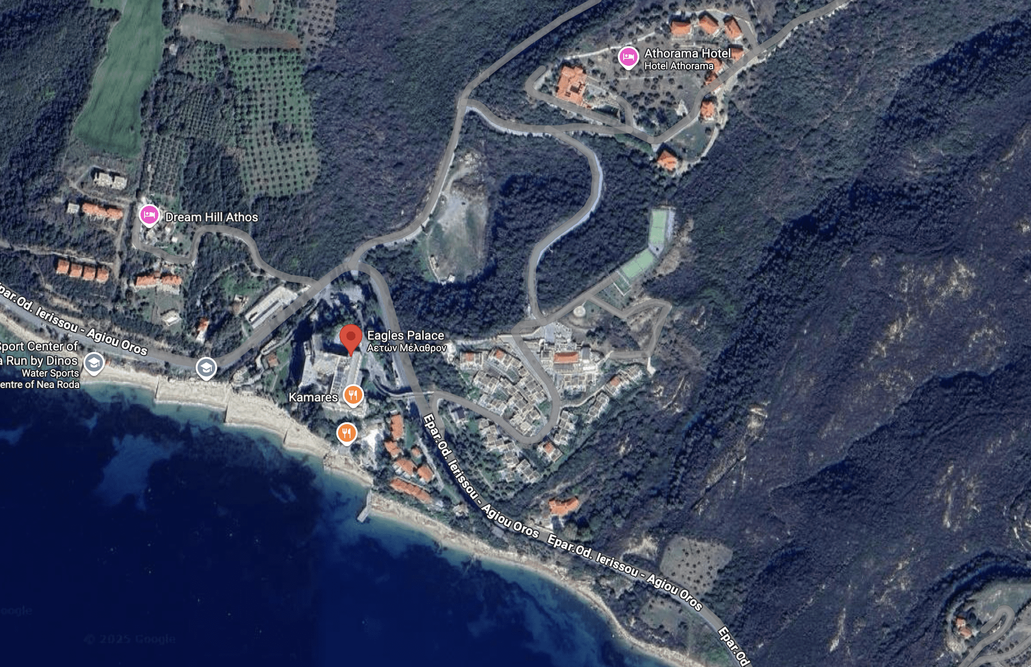 A coastal village with winding roads and clustered buildings near the sea.