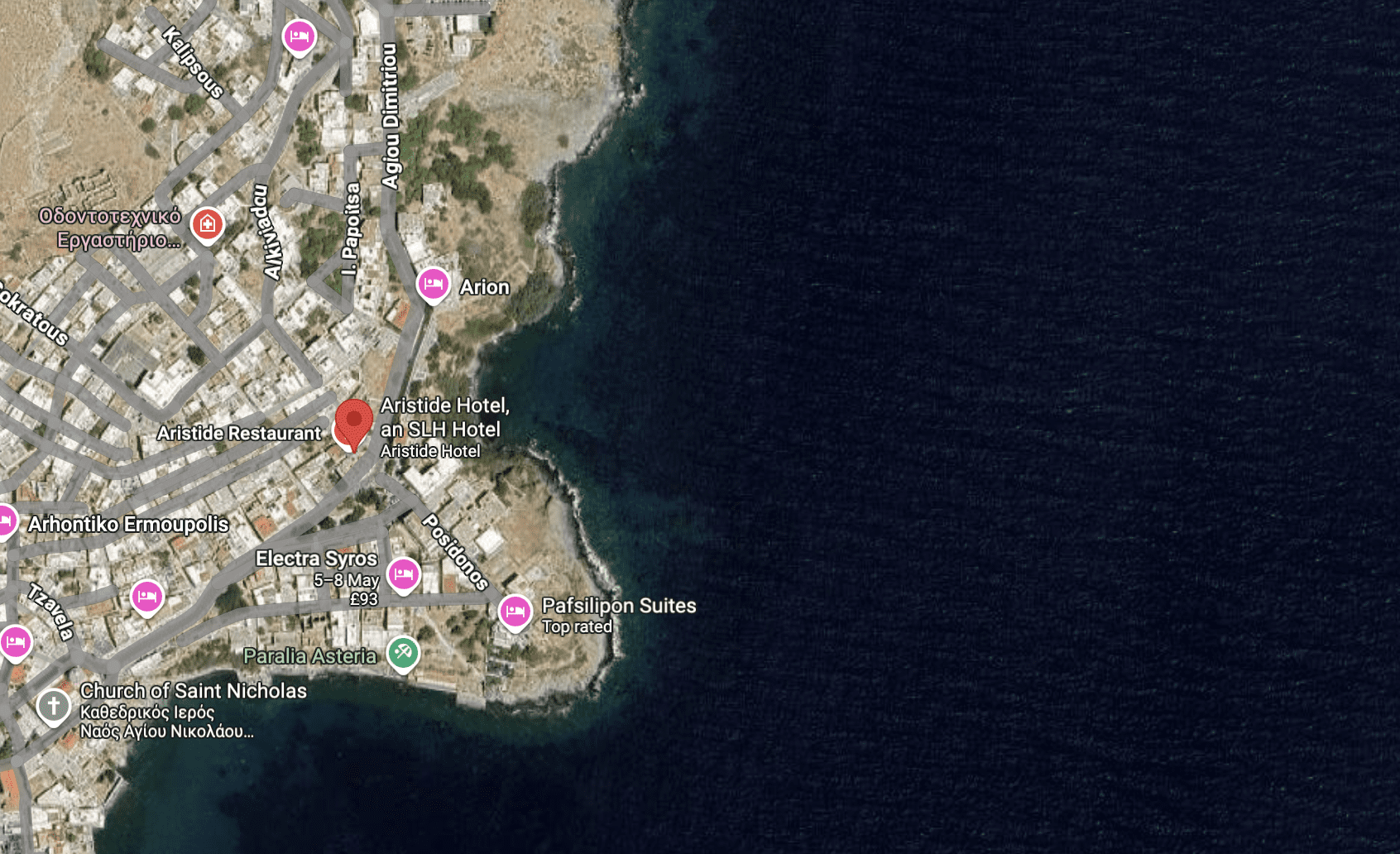 A coastal area with rocky terrain and a nearby town.