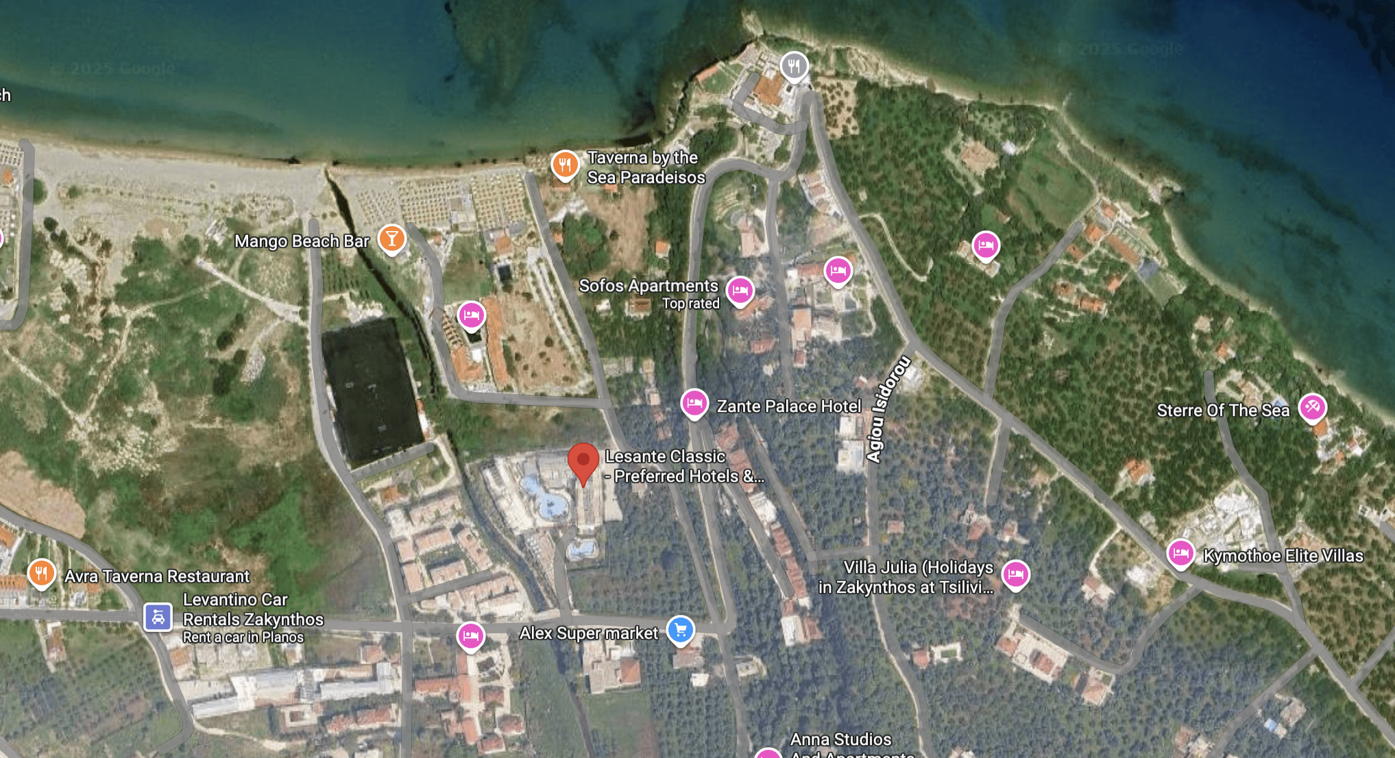 A detailed satellite view of a coastal urban area with roads and buildings.