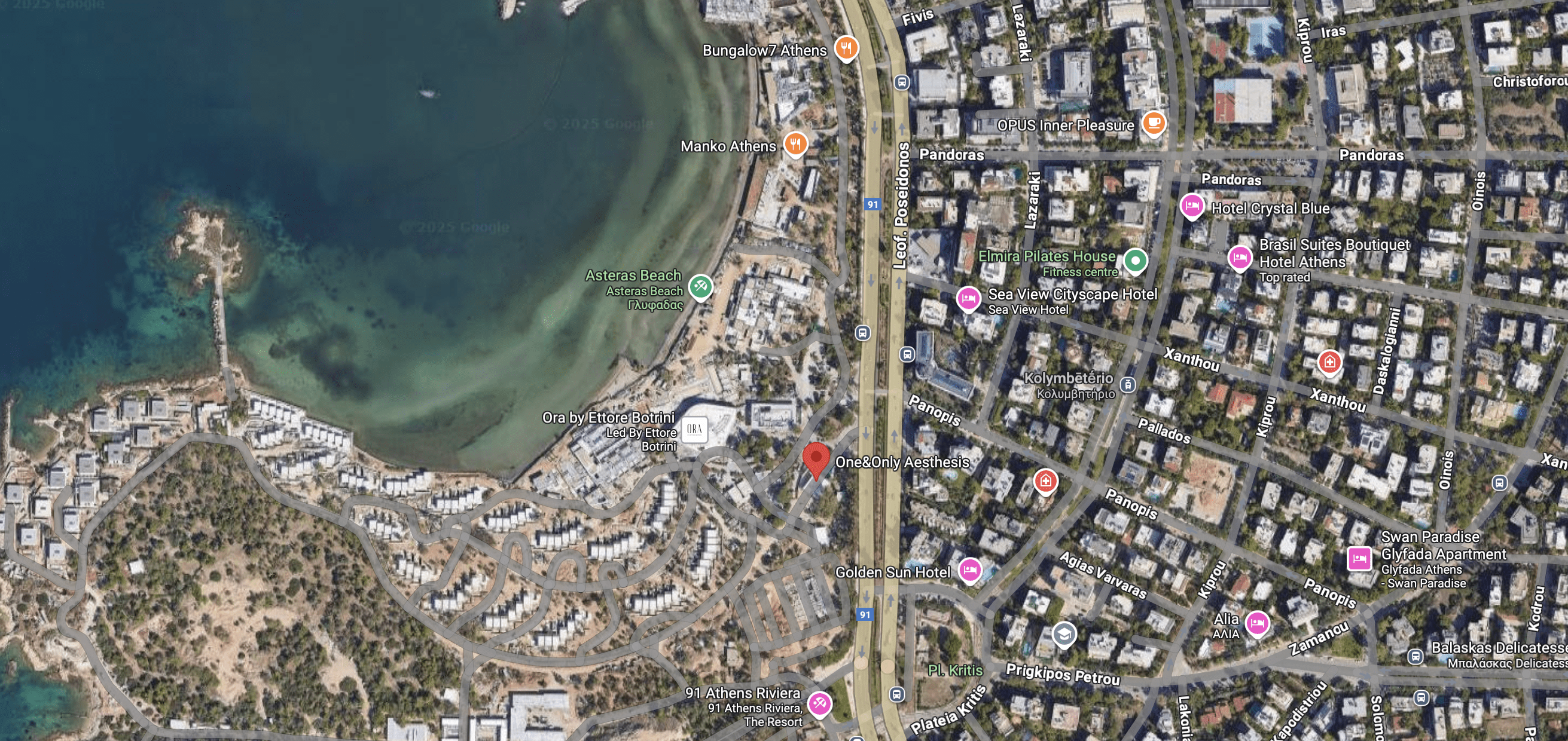 Aerial view of a coastal urban area with buildings and roads.