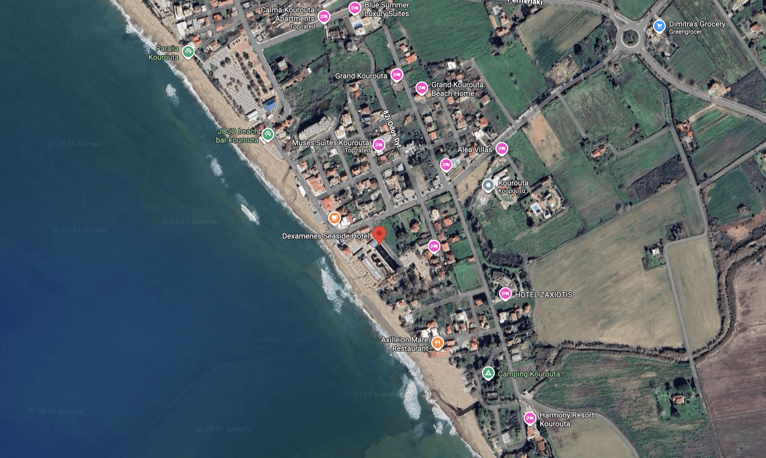 Aerial view of a coastal town with buildings and a beach.