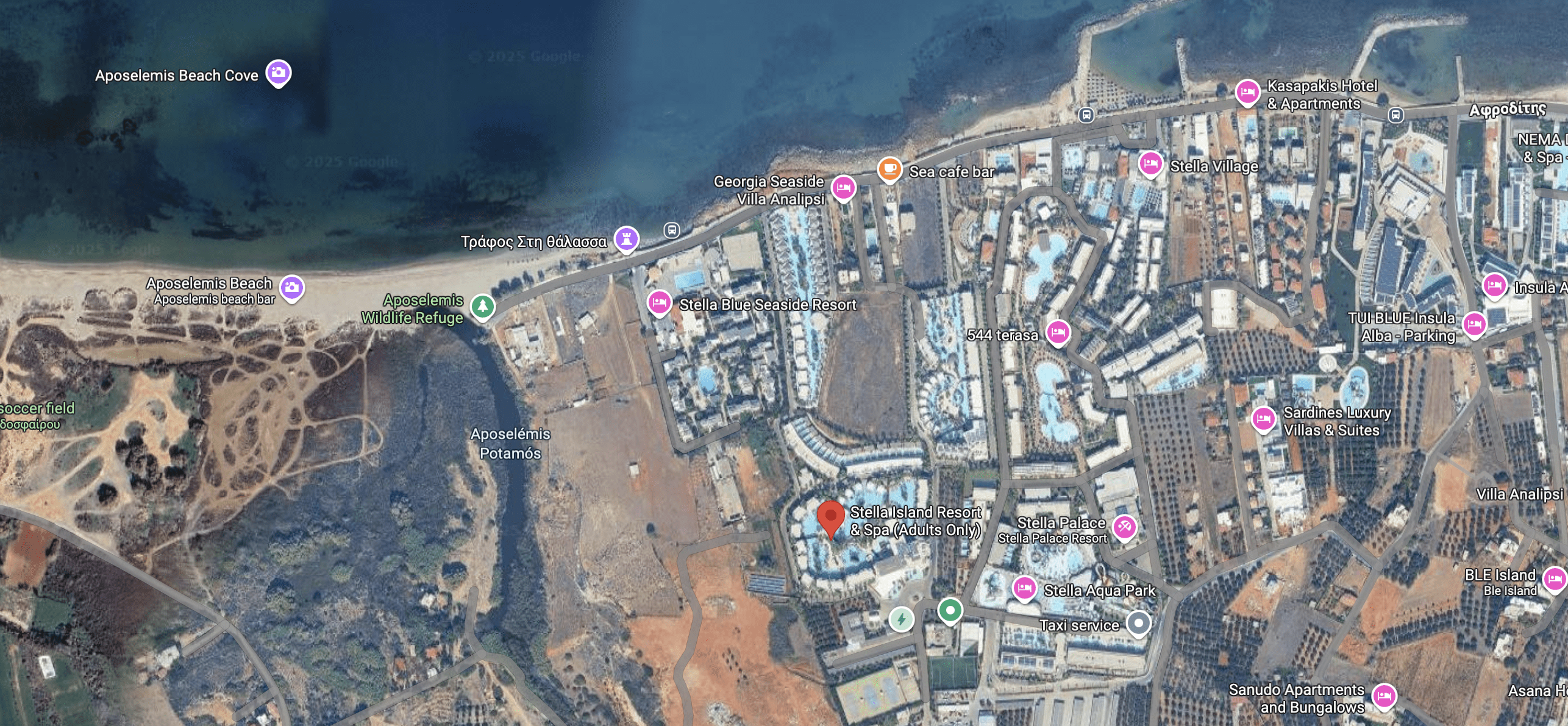Aerial view of a coastal area with buildings and roads.