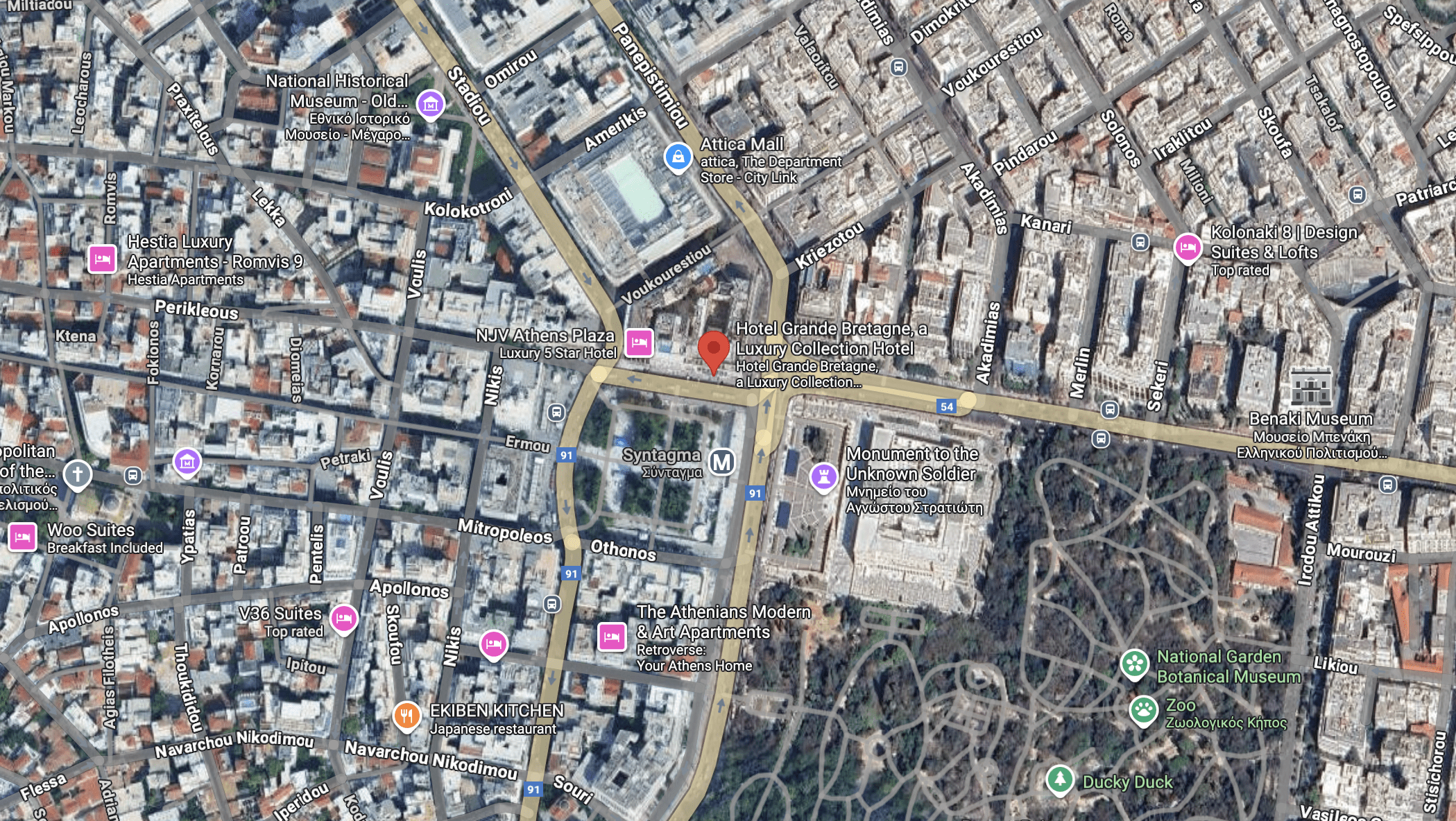 Aerial view of a busy city intersection with buildings and roads.